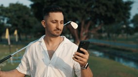 Portrait of man golf player with driver checking mobile phone chat in elite sports club. Golfer publishes post in social media via smartphone. Online betting on tournament results - Powered by Shutterstock - Get 15% off with code: PIKWIZARD15