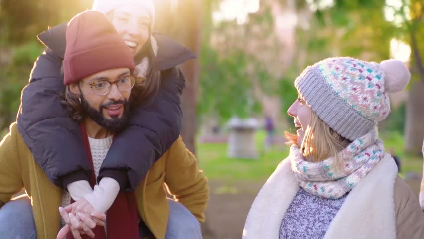 Cheerful group of friends having fun together outdoors. High quality 4k footage