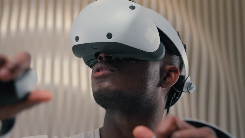 3d world gaming African American man male guy using controllers VR helmet virtual augmented reality glasses high-tech Internet technology futurism cyber game interface playing innovation metaverse - Powered by Shutterstock - Get 15% off with code: PIKWIZARD15