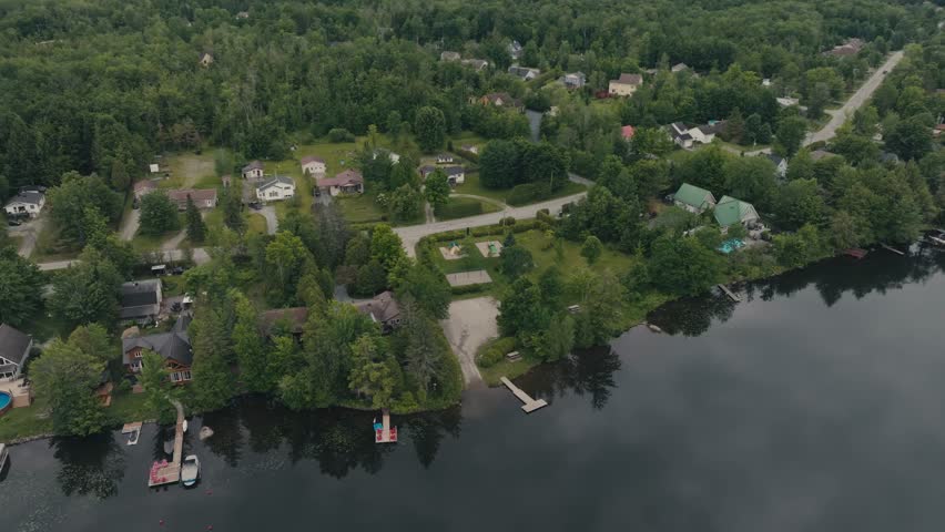 Aerial View Of Jetties In Lake With Houses In Sherbrooke, Canada - Drone Shot