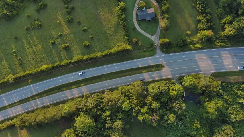 Aerial Birds eye view of highway at sunrise in rural South Carolina 