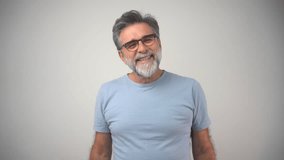 Attractive mature handsome man with stylish hair and beard laughs at funny story from friend with crossed hands and closed eyes. Cheerful hipster guy smiles happily, has excited expression, dresssed  - Powered by Shutterstock - Get 15% off with code: PIKWIZARD15