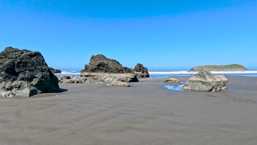 Coral rocks sit on Pacific Ocean beach