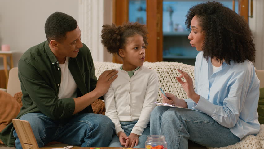 African American doctor speech therapist teaching treat child pronunciation problems defects sounds letter syllable word alphabet man woman together learning parenting mother father daughter educate