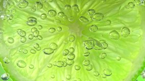 Super Slow Motion Macro Shot of Lime Slice in Water with Air Bubbles at 1000fps. - Powered by Shutterstock - Get 15% off with code: PIKWIZARD15