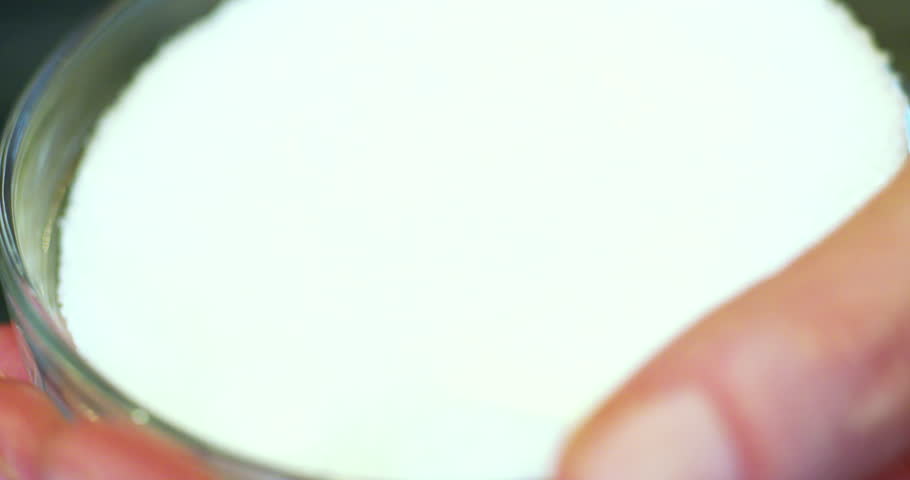 Hand pinches salt in a small bowl