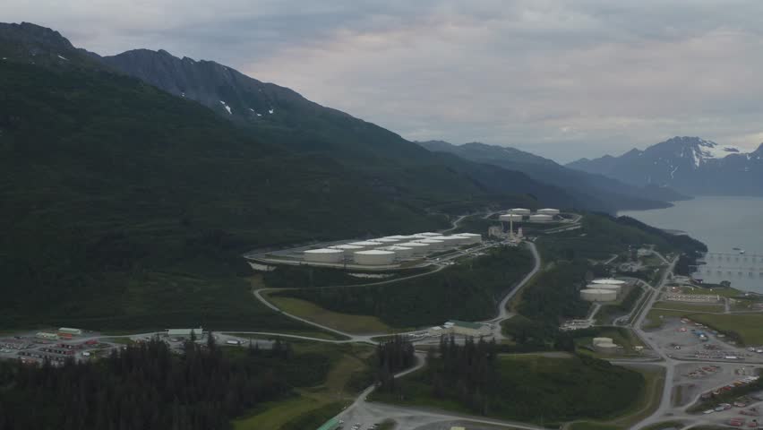 Aerial view of oil tanks at Valdez Marine Terminal at the end of the Trans-Alaska oil pipeline in Valdez, Alaska - 4K Drone