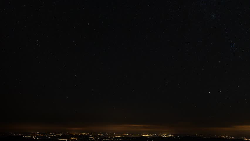 Motion of Star Trails over the Appenzelland with warm city light of St. Gallen and Bodensee Lake area, Switzerland