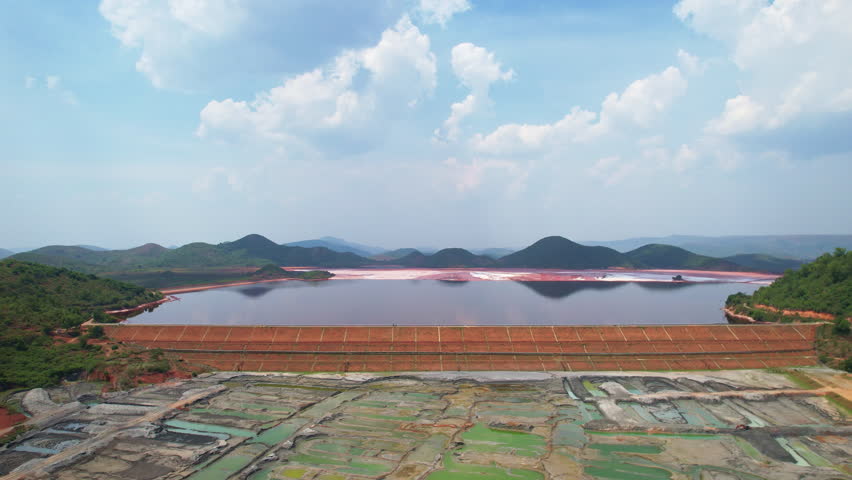 Aerial Top view of red mud pond in Koraput, Odisha. It features structured embankments and compartmentalized ponds, likely part of an industrial or mining site.
