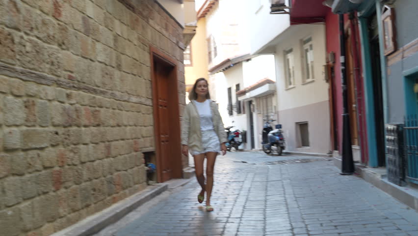 A woman is walking and enjoying the old town of Antalya.