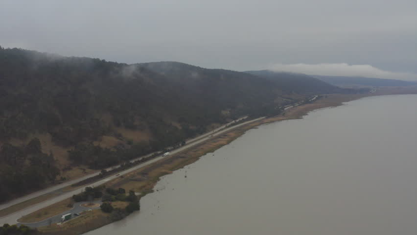 Drone flying high over the highway next to Lake George, Canberra ACT