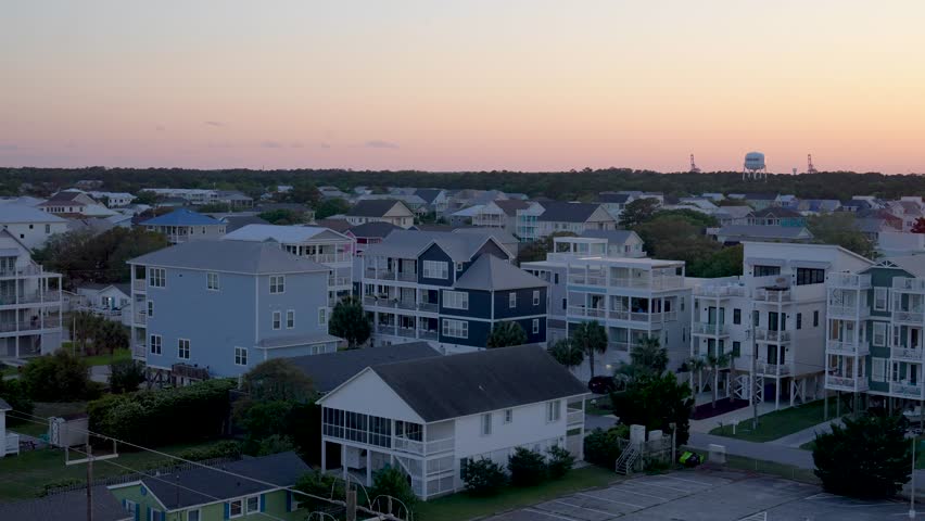 Wide shot of the sunset over beach houses in Carolina Beach, NC.