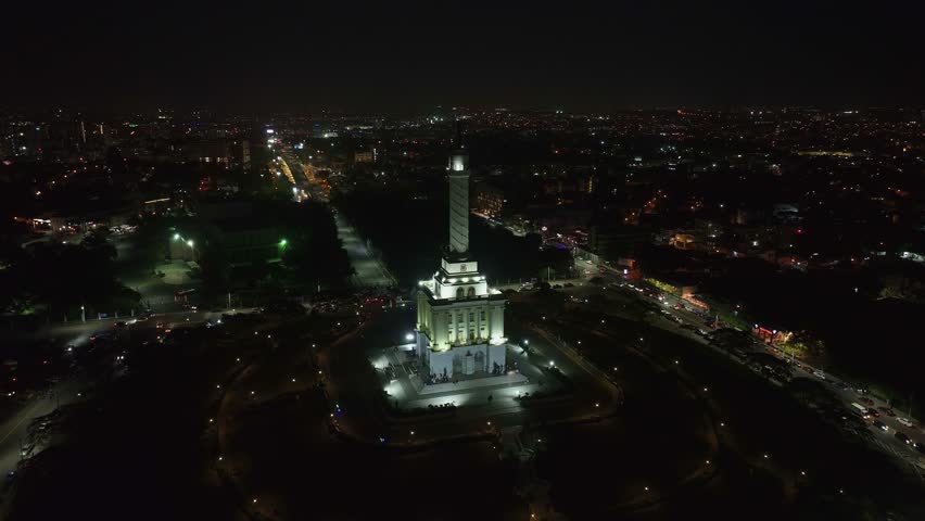 Drone View of Santiago de los Caballeros, Dominican Republic at Night. Monument to the Heroes of Restoration and City Lights