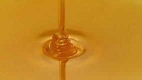 Honey pouring isolated on yellow golden background. Liquid Thick honey dripping over dark background, flowing syrup. Healthy food concept diet HD - Powered by Shutterstock - Get 15% off with code: PIKWIZARD15