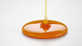 Golden Honey pouring isolated on white background. Liquid Thick honey dripping over dark background, flowing syrup. Healthy food concept diet HD - Powered by Shutterstock - Get 15% off with code: PIKWIZARD15