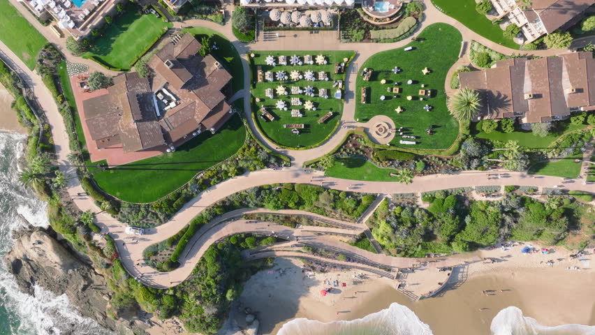 The highresolution aerial image captures Laguna Beach at sunrise, with lush green landscapes, resorts, and the stunning coastline. Ideal for relaxation, recreation, and nature lovers