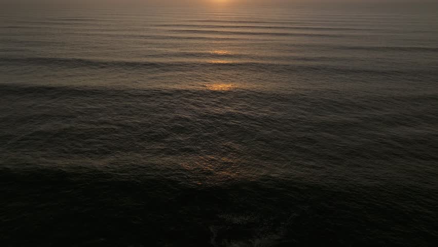 Aerial drone view of a perfect sunset over the Pacific Ocean during a golden and colorful sunset in Pacific Beach San Diego California with people enjoying the beautiful views by Crystal Pier