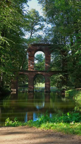old ancient aqueduct in romantic Arcadia park, antique Roman architecture made of brick wall, historical building, Poland 4k