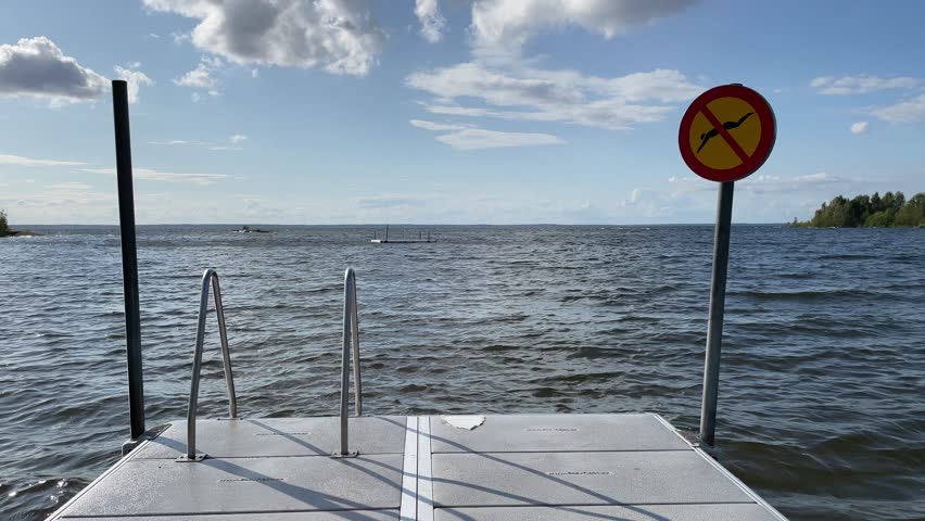 Summerday and swimming.  No diving sign. Shallow water. August 2024. Vänern, Västergötland, Sweden.