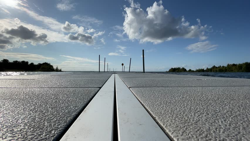 Low angle of a bridge. Summerday and swimming. August 2024. Vänern, Västergötland, Sweden.