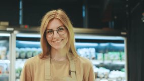 A cheerful shopkeeper stands proudly in their modern grocery store, filled with vibrant products, showcasing dedication to community engagement and customer satisfaction - Powered by Shutterstock - Get 15% off with code: PIKWIZARD15