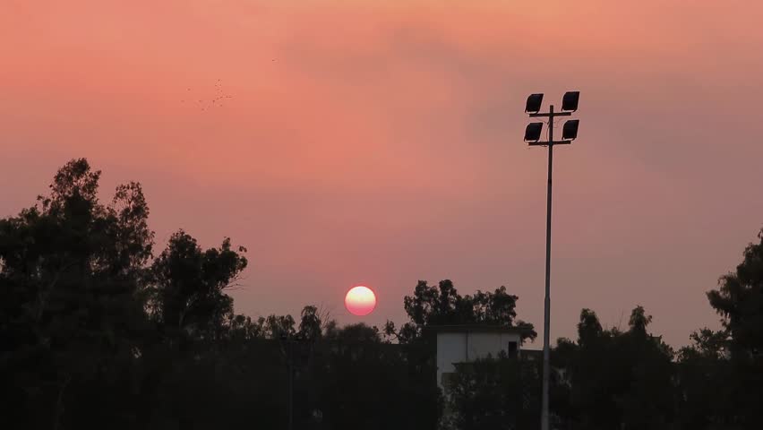 Sunset behind the trees golden hours in sky and beautiful evening in Faisalabad Pakistan 