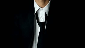 businessman with black suit and white shirt fixing tie on black adjusting necktie business background - Powered by Shutterstock - Get 15% off with code: PIKWIZARD15