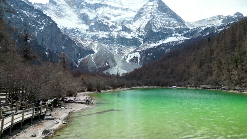 Drone shot of Pearl lake with Mount Xiannairi in the background of the scenic and breathtaking Yading nature reserve, located in Garze Tibetan Autonomous Prefecture, Sichuan