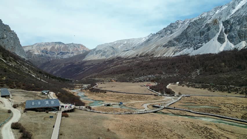 Drone shot of the scenic and breathtaking Yading nature reserve luorong pasture with boardwalk and rest area for tourist to appreciate nature. Located in Garze Tibetan Autonomous Prefecture, Sichuan