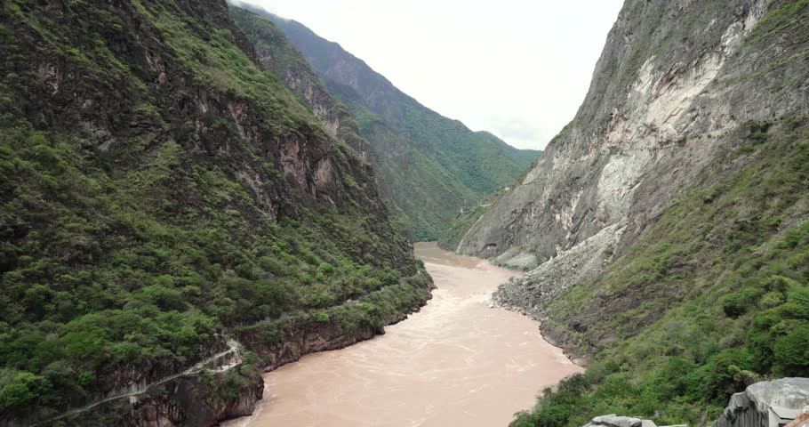 View to the steep valley of Tiger Leaping Gorge with meandering Yangtze River below in the spring of Yunnan, China.