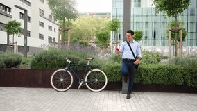 Stylish Businessman with bike using cell phone to call outside the workplace - Powered by Shutterstock - Get 15% off with code: PIKWIZARD15