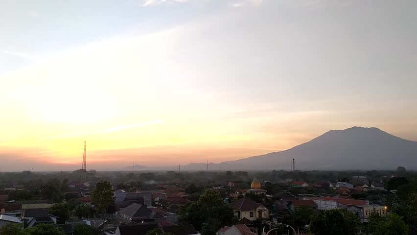 sragen, indonesia, 
The sun rose against the backdrop of Mount Lawu and thin smoke could be seen from several houses. recording in timelapse