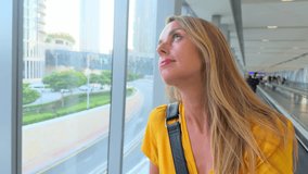 Woman Observing Cityscape Through Glass Window, Dubai, UAE. High quality footage - Powered by Shutterstock - Get 15% off with code: PIKWIZARD15
