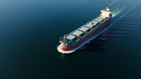 Dry bulk cargo vessel ship underway in calm sea, merchant ship to transport bulk cargo such as grains ore coal. Aerial view - Powered by Shutterstock - Get 15% off with code: PIKWIZARD15