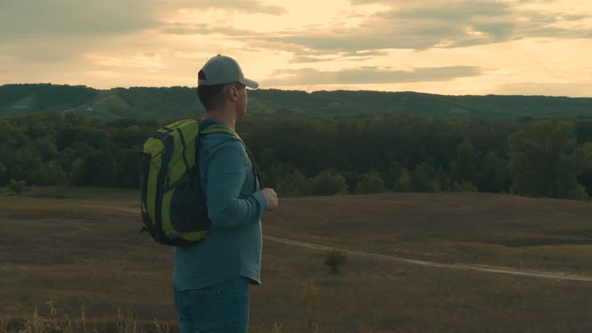 man with backpack mountains sunset sky, man traveling with tourist backpack landscape nature mountains sky, hiking mountains outdoors sky sun, traveling men vacation, adult man backpack watching