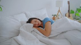 Asian beautiful woman lying down on bed in bedroom in morning at home. Attractive young girl feel happy and relax, sleeping with cozy pillow and blanket enjoy early day in holiday weekend in house. - Powered by Shutterstock - Get 15% off with code: PIKWIZARD15