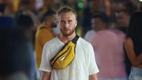 Many people walk city street time lapse. Alone man stand among crowd. Rush hour timelapse. One frozen sad lonely guy look camera. Lot busy pedestrians pass by. Loneliness solitude concept. Neon light. - Powered by Shutterstock - Get 15% off with code: PIKWIZARD15