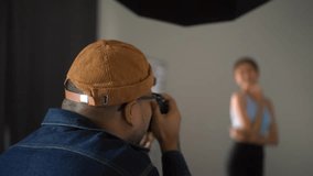 Behind shooting of Professional man photographer working shooting woman model using digital camera and flash studio in studio on white background. photography concept.
 - Powered by Shutterstock - Get 15% off with code: PIKWIZARD15