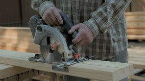 A skilled individual is using a circular saw to cut lumber for a wooden structure in a serene forest setting. The sunlight filters through the trees, casting gentle shadows on the work area. Close-up - Powered by Shutterstock - Get 15% off with code: PIKWIZARD15