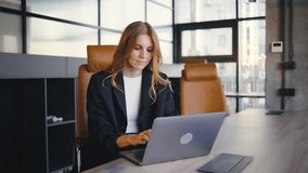 A professional woman is engaged in her work on a laptop within a modern office setting, showcasing the synergy between technology and innovation in todays business world - Powered by Shutterstock - Get 15% off with code: PIKWIZARD15