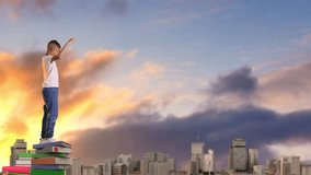 Boy climbing on top of stack of colorful books and raising his hands up in triumph - Powered by Shutterstock - Get 15% off with code: PIKWIZARD15