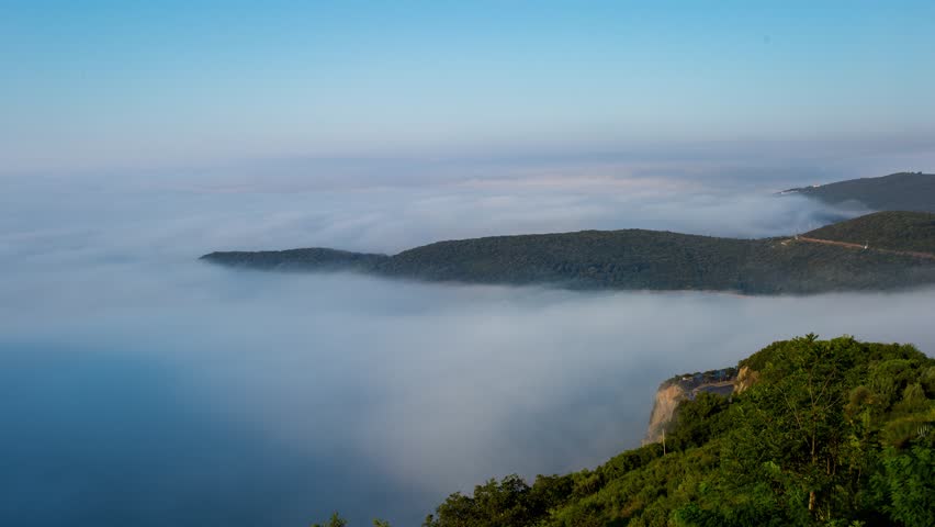 Timelapse Of Fog Fading Away Above The Jaz Beach In Budva, Montenegro. aerial, wide shot