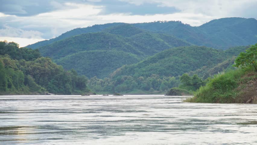 Quiet Mekong river in the afternoon, scenic nature hill and mountain on background