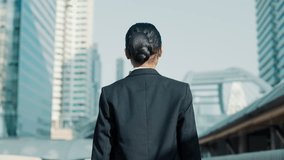 Back View of a Successful Young Business Woman Stepping into a New Phase of Life, Dressed in Stylish Gray Suit. Young Dark-Haired Woman Walking Through the City and Taking in the Scenery - Powered by Shutterstock - Get 15% off with code: PIKWIZARD15