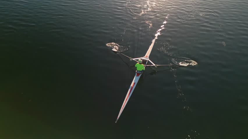 Aerial view Rowing Crew Training at Dawn in Halifax Bay Canada. A sports rowing boat with a dedicated crew of young athletes is captured by a drone as they train at dawn in Halifax Bay.