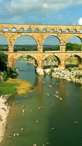 Aerial shot of famous Pont du Gard, the Roman aqueduct bridge of Nimes over the Gardon River, France, vertical video