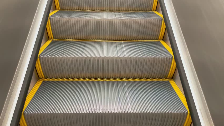 Slow Moving Metal Escalator Stairs In Sunlight