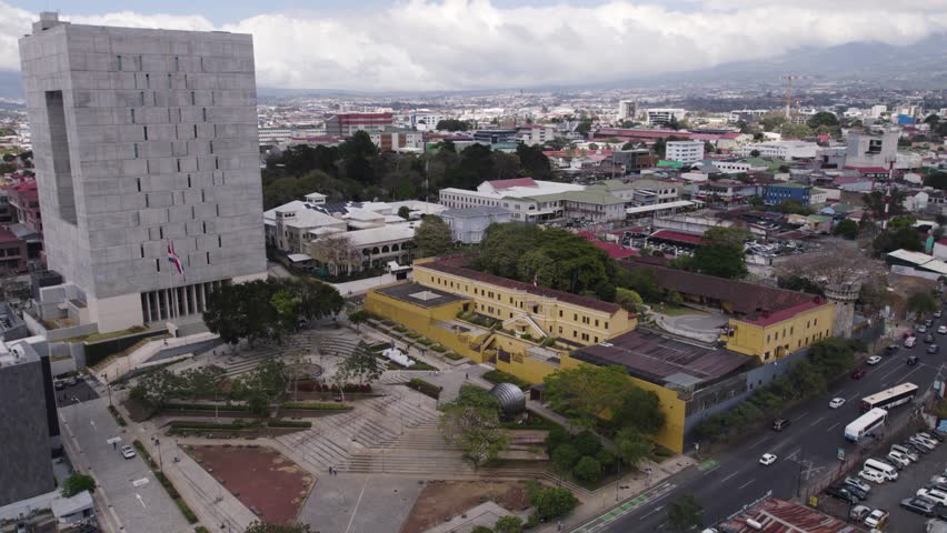 Aerial view of the National Museum of Costa Rica surrounded by the urban landscape of San Jose. Dolly Shot