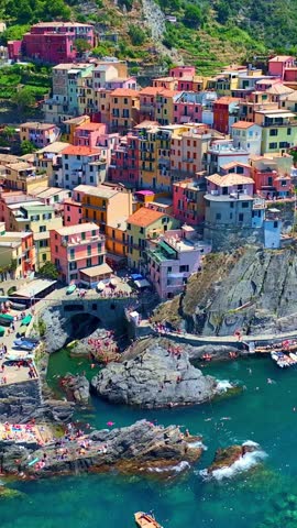 Vertical video of Manarola village in Cinque Terre, aerial view, vacation on Italian riviera, drone view of Cinque Terre, Manarola fishing village in Italy, holiday on Ligurian coast. 