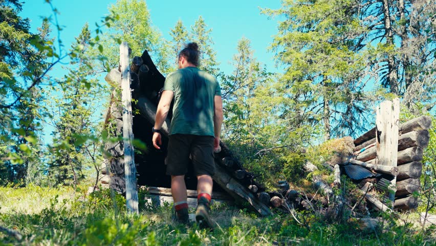 A Man is Inspecting a Kettle While Camping Along the Seterdjupna to Malitjønna Route in Indre Fosen, Trøndelag, Norway - Static Shot